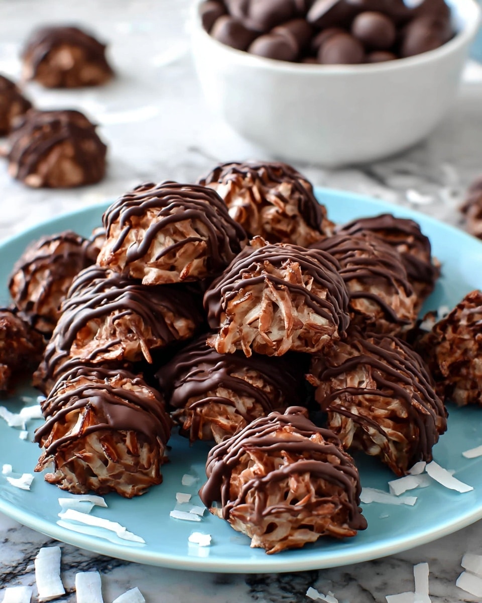 The image shows a close-up of three chocolate clusters on a white marbled surface. Each cluster has a rough, lumpy texture made from shredded coconut and chocolate chips mixed together. The top surface of each cluster is covered with smooth, glossy melted chocolate drizzled unevenly, adding shine and contrast to the rough base. The clusters are dark brown with lighter brown coconut flakes visible through the chocolate. Some loose chocolate chips are scattered around the clusters. The background is softly blurred, highlighting the texture and layers of the chocolate clusters in the front. photo taken with an iphone --ar 4:5 --v 7