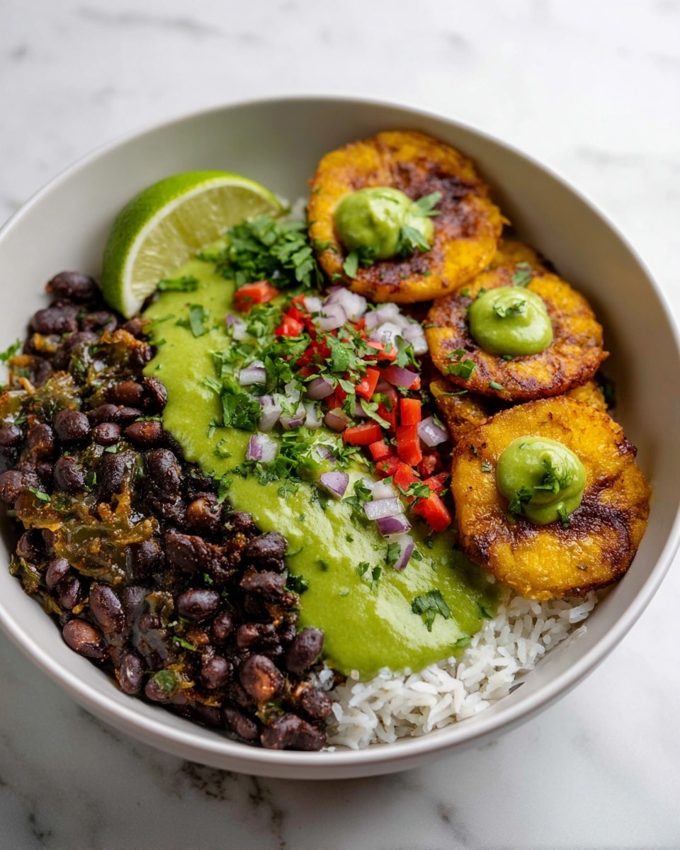 A white bowl holds a layered dish starting with a base of white rice on the left side. On top of the rice, there are cooked black beans mixed with small pieces of onion and red bell pepper, covered in a smooth, bright green sauce spread in two thick lines. To the right, there are several golden-brown fried plantain slices, each topped with a small dollop of the same green sauce. The dish is garnished with finely chopped red onion, red bell peppers, and green herbs scattered over the beans and rice, with a few fresh cilantro leaves visible at the front edge of the bowl and a lime wedge positioned at the back near the plantains. The bowl sits on a white marbled surface. Photo taken with an iphone --ar 4:5 --v 7
