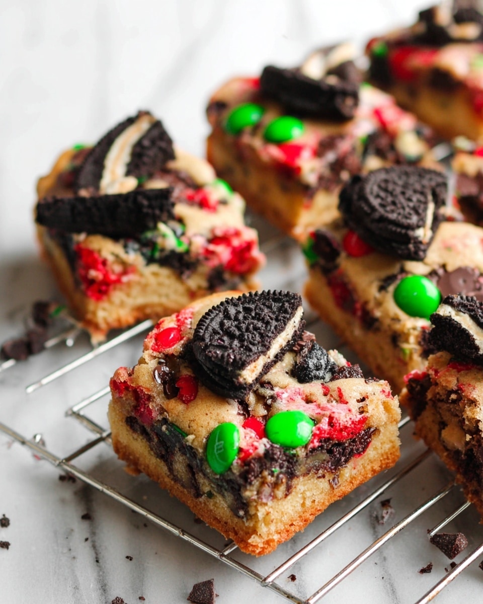 The image shows nine square pieces of a dessert bar laid out on a cooling rack over a white marbled surface. Each piece has a light tan base layer with a soft, moist texture, embedded with bright red and green candy-coated chocolates, and topped with broken black and red cookies. Scattered milk chocolate chips add texture and contrast across the bars. Whole black cookies and additional chocolate chips are scattered nearby on the white marbled surface. photo taken with an iphone --ar 4:5 --v 7