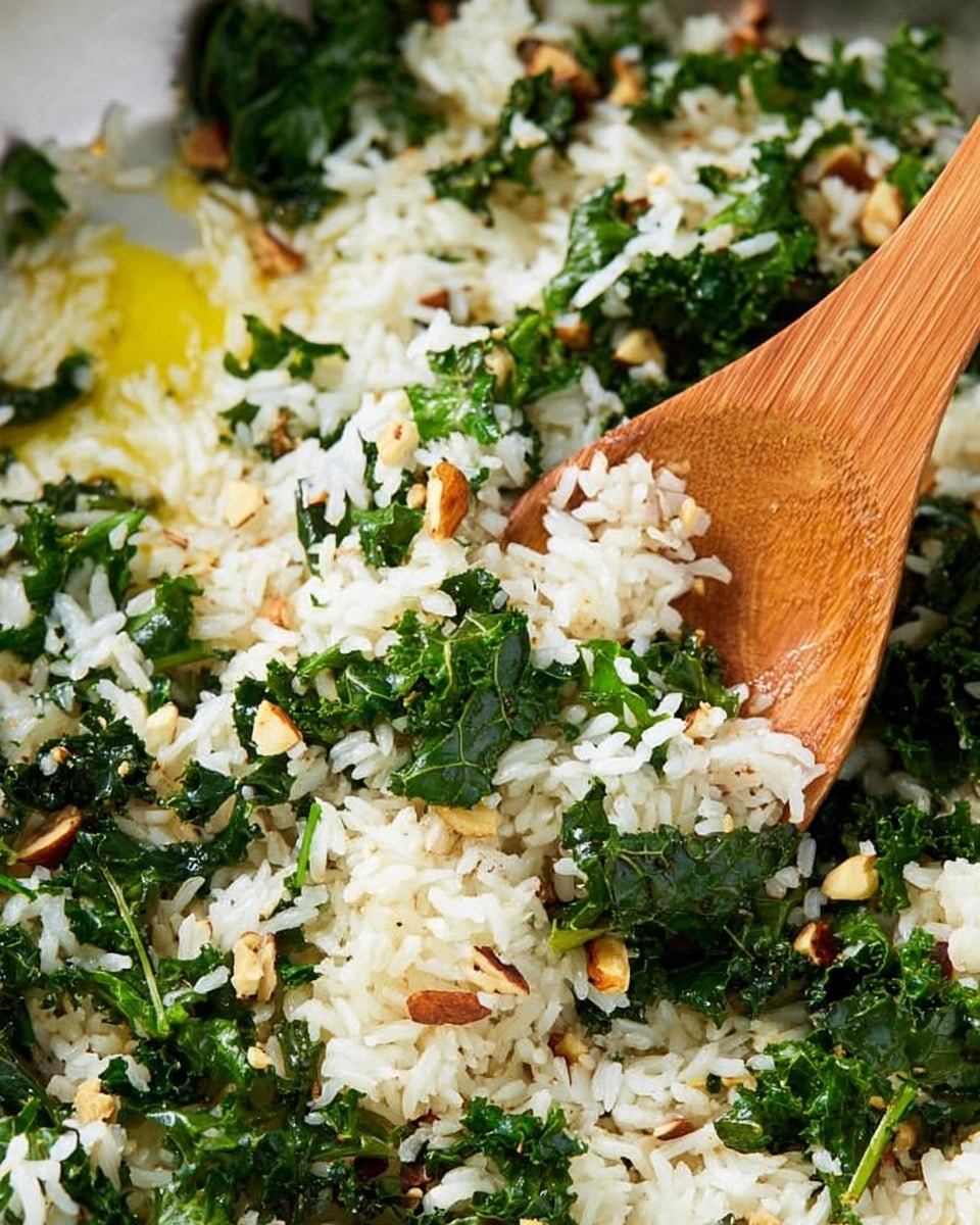 The dish shows a grilled chicken breast covered in a dark, shiny, and slightly oily sauce with small chopped green herbs sprinkled on top. The chicken is placed on the left side on a white plate, with the bottom left corner slightly sliced to reveal the tender inside. To the right of the chicken is a heap of white rice mixed with dark green kale and topped with coarsely chopped brown nuts. The background is a white marbled texture, and part of a metal knife is cutting through the rice near the bottom center of the image. photo taken with an iphone --ar 4:5 --v 7