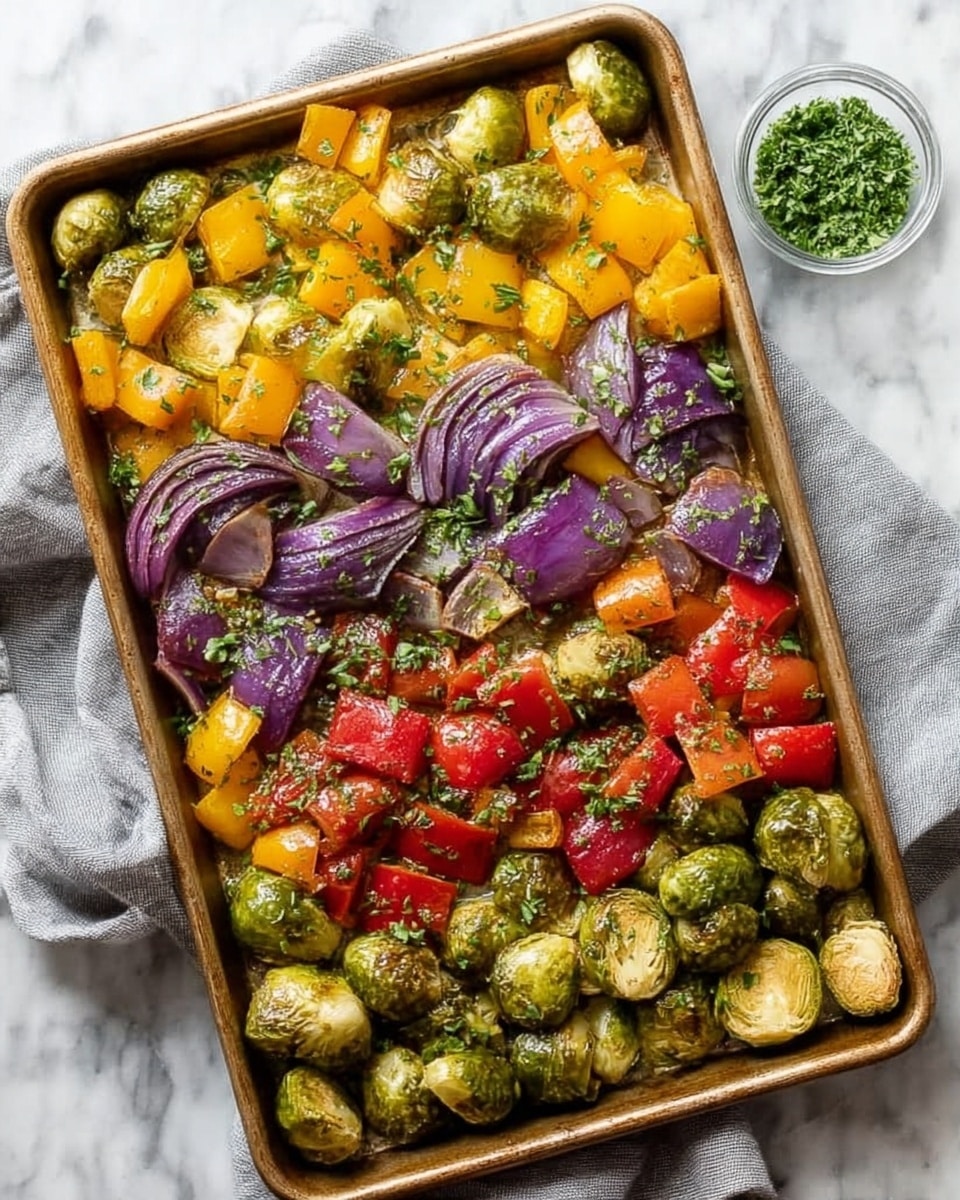 A rectangular baking tray filled with three layers of roasted vegetables: the bottom layer has halved Brussels sprouts with a green and slightly charred texture; the middle layer is colorful chopped bell peppers mostly yellow and red, some pieces showing a cooked but firm look; the top layer consists of purple onion wedges with a soft and caramelized surface, sprinkled with small green herb pieces. The tray sits on a soft light gray cloth, placed on a white marbled surface, next to a small transparent bowl of finely chopped green herbs. photo taken with an iphone --ar 4:5 --v 7