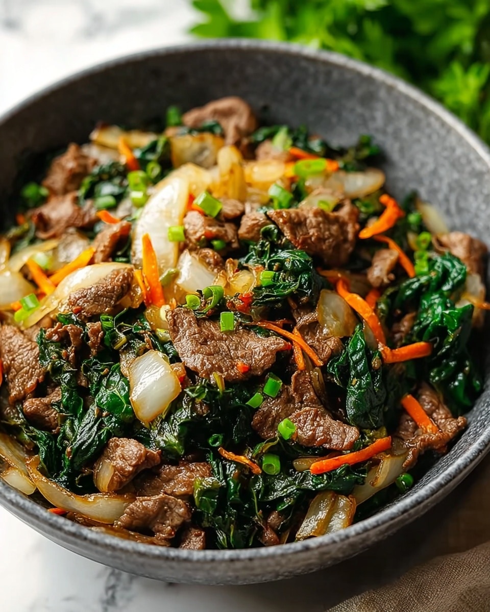 A close-up of a grey bowl filled with a stir-fry dish. The dish has three main layers: the first layer at the bottom is cooked leafy greens with dark green color and wilted texture, the second layer is stir-fried sliced white onions slightly translucent, and the top layer is browned, thinly sliced beef pieces mixed with small bits of orange carrot strips and green herbs scattered evenly. The grey bowl sits on a white marbled surface with some parsley blurred in the background. Photo taken with an iphone --ar 4:5 --v 7